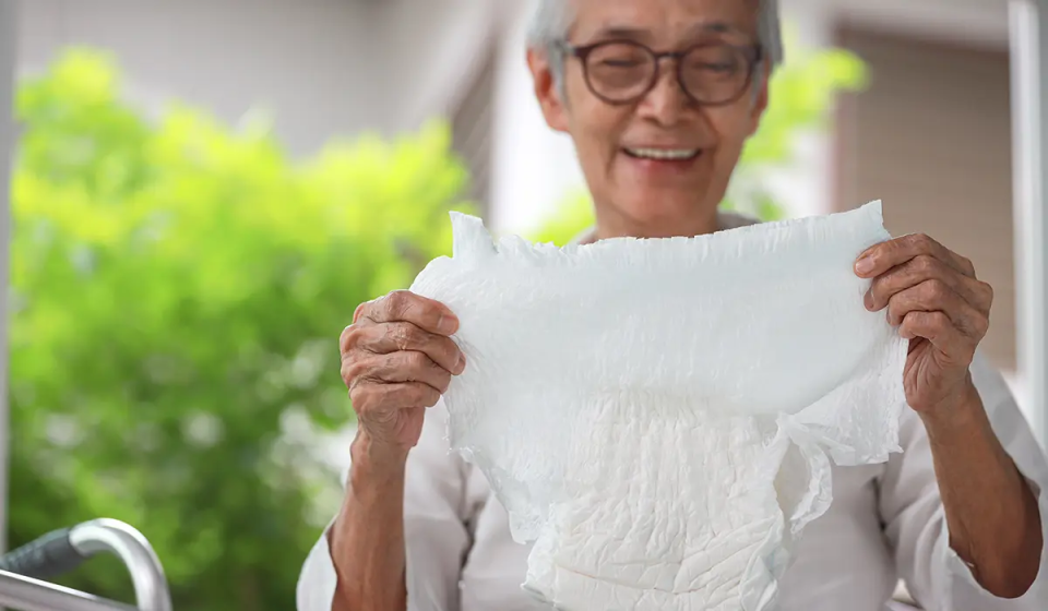 Image of persona holding adult diaper
